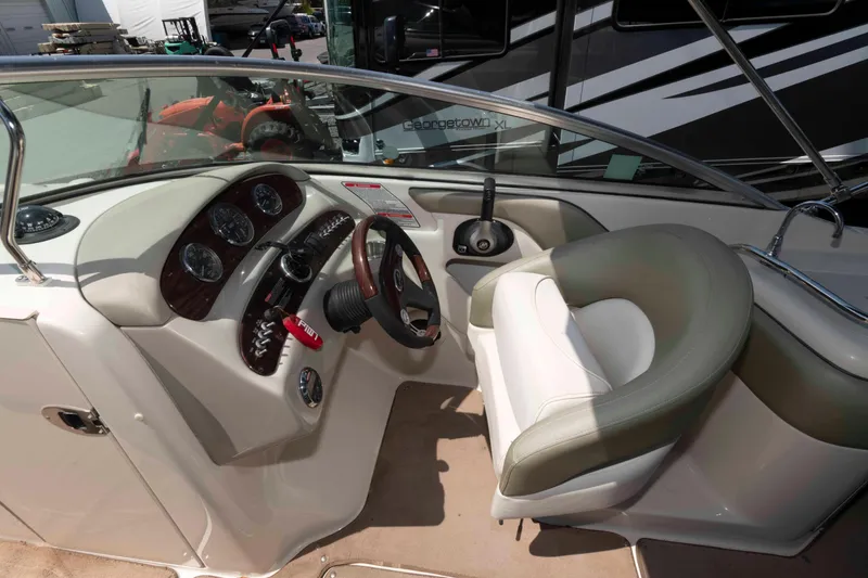 Slide: The Image of 2006 Sea Ray 240 Sundeck boat interior with steering wheel and dashboard controls. - 4