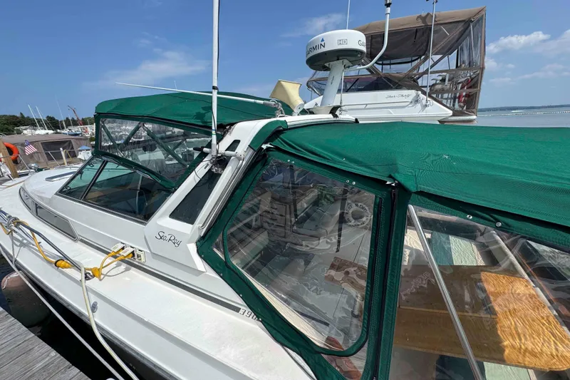Slide: The Image of 1986 Sea Ray 390 Express Cruiser docked with green canopy and Garmin radar. - 2