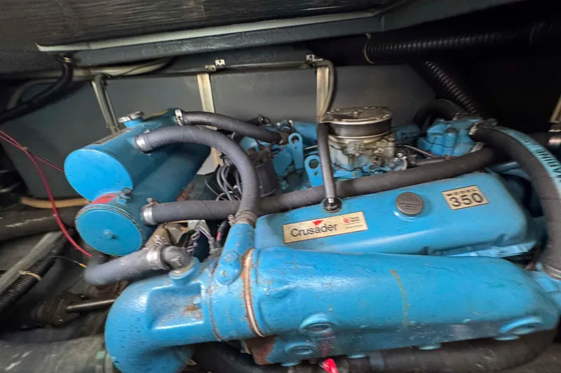 Slide: The Image of 1986 Sea Ray 390 Express Cruiser engine, Crusader model 350, blue with hoses. - 20