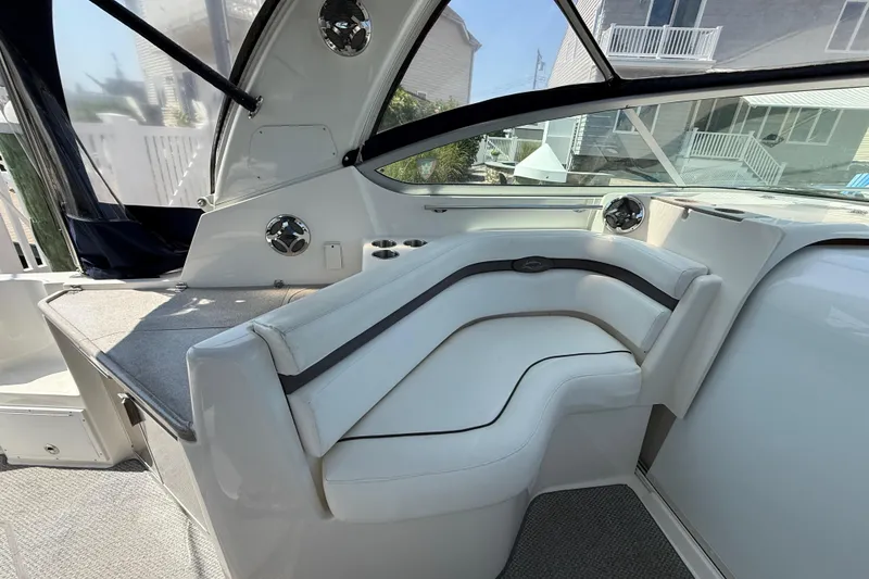Slide: The Image of 2009 Rinker 340 Express Cruiser interior with white seating and modern design. - 12