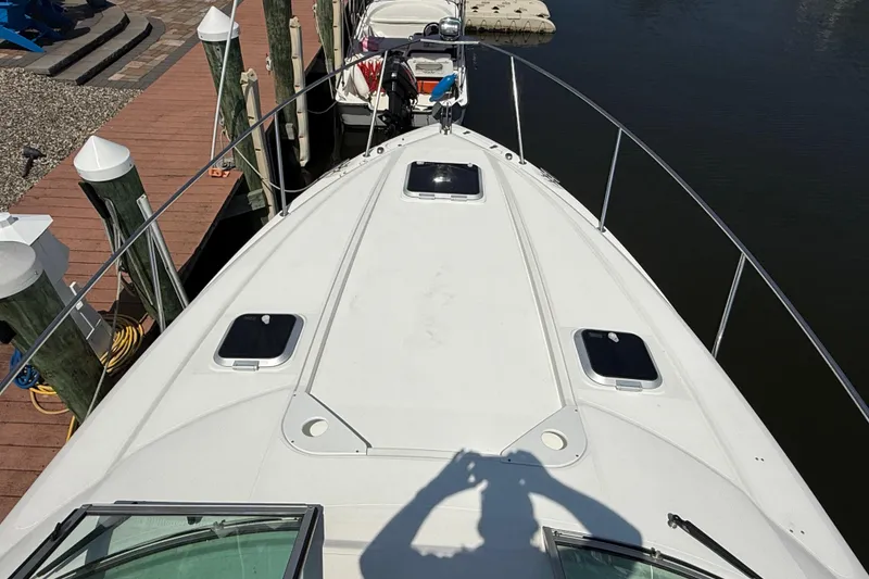 Slide: The Image of 2009 Rinker 340 Express Cruiser docked, view from bow, sunny day. - 17