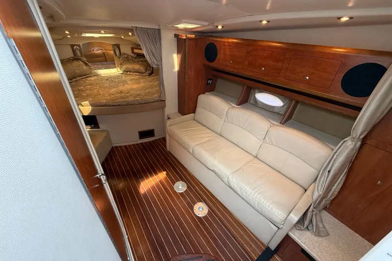 Slide: The Image of 2009 Rinker 340 Express Cruiser interior with cozy seating and elegant wood finishes. - 21