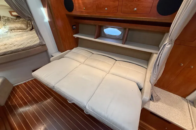 Slide: The Image of 2009 Rinker 340 Express Cruiser interior with beige leather seating and wood accents. - 23