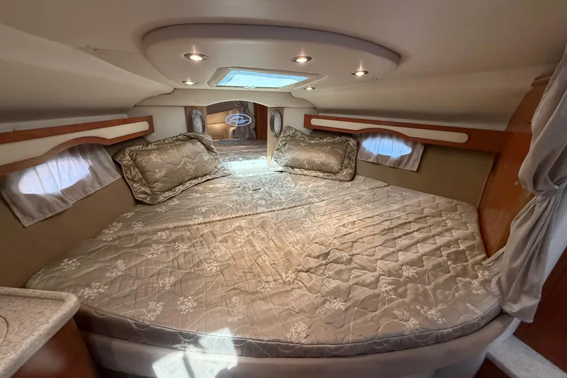 Slide: The Image of Luxurious cabin interior of a 2009 Rinker 340 Express Cruiser with elegant bedding. - 25