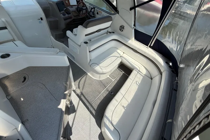 Slide: The Image of 2009 Rinker 340 Express Cruiser interior with white seating and modern helm. - 30