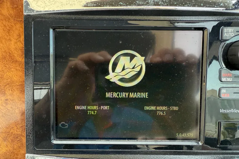 Slide: The Image of Display screen showing Mercury Marine engine hours for a 2009 Rinker 340 Express Cruiser. - 31