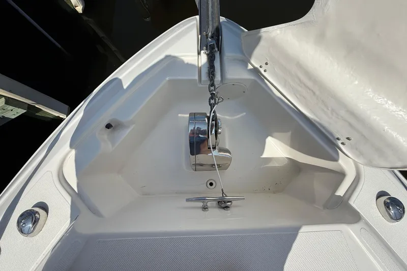 Slide: The Image of 2009 Rinker 340 Express Cruiser anchor compartment with chain and cleat. - 32