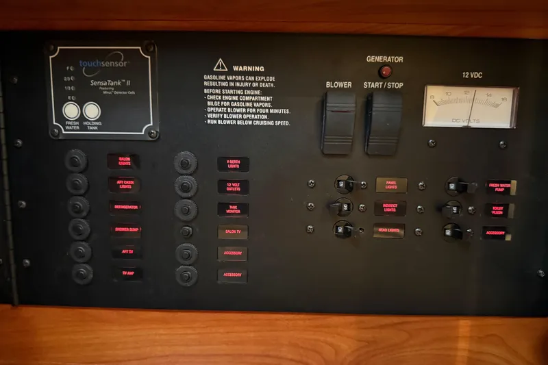 Slide: The Image of Control panel of a 2009 Rinker 340 Express Cruiser with various switches and indicators. - 36
