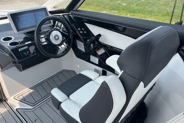 Slide: The Image of 2021 Yamaha Boats 275 SE cockpit with modern steering and control panel. - 14
