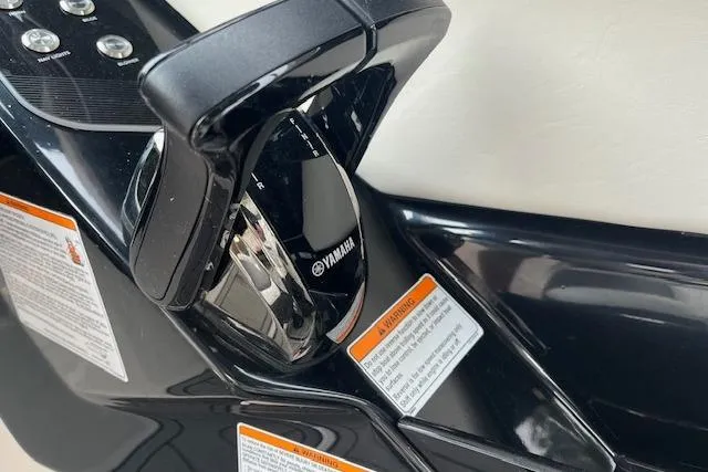Slide: The Image of Close-up of 2021 Yamaha Boats 275 SE throttle control with warning labels. - 17