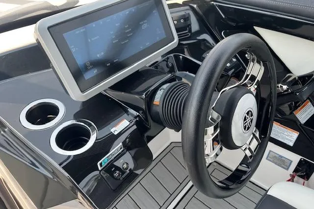 Slide: The Image of 2021 Yamaha Boats 275 SE dashboard with touchscreen and steering wheel. - 18