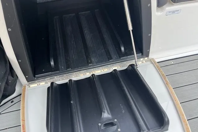 Slide: The Image of Open storage compartment on 2021 Yamaha Boats 275 SE, showcasing interior details. - 25