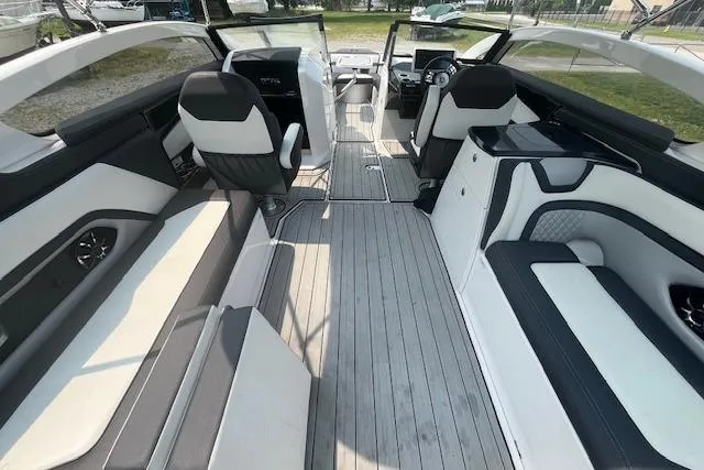 Slide: The Image of 2021 Yamaha Boats 275 SE interior with sleek seating and modern dashboard design. - 35