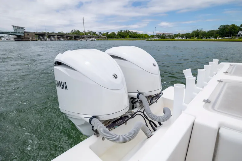 Slide: The Image of Twin Yamaha outboard engines on a 2012 Contender 30 Tournament boat, near a bridge. - 10