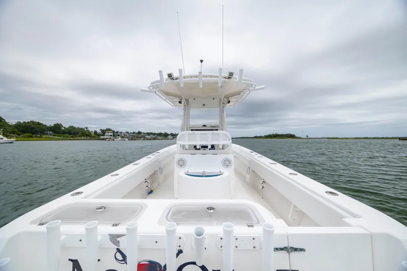 Slide: The Image of 2012 Contender 30 Tournament boat on calm waters under cloudy skies. - 12