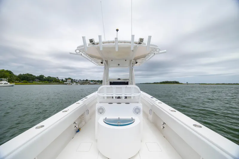 Slide: The Image of Contender 30 Tournament 2012 boat on calm water under cloudy sky. - 13