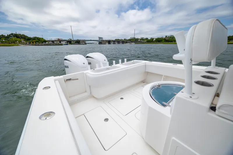Slide: The Image of 2012 Contender 30 Tournament boat with Yamaha engines on a calm waterway. - 15