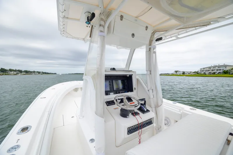 Slide: The Image of 2012 Contender 30 Tournament boat interior with steering console on calm water. - 17