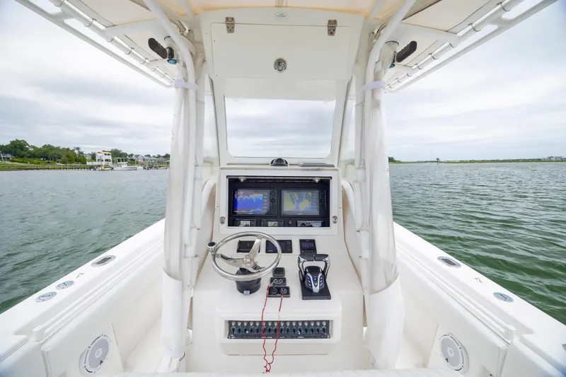 Slide: The Image of 2012 Contender 30 Tournament boat helm with navigation system on open water. - 18