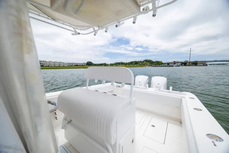 Slide: The Image of 2012 Contender 30 Tournament boat on water, featuring white seating and scenic shoreline view. - 20