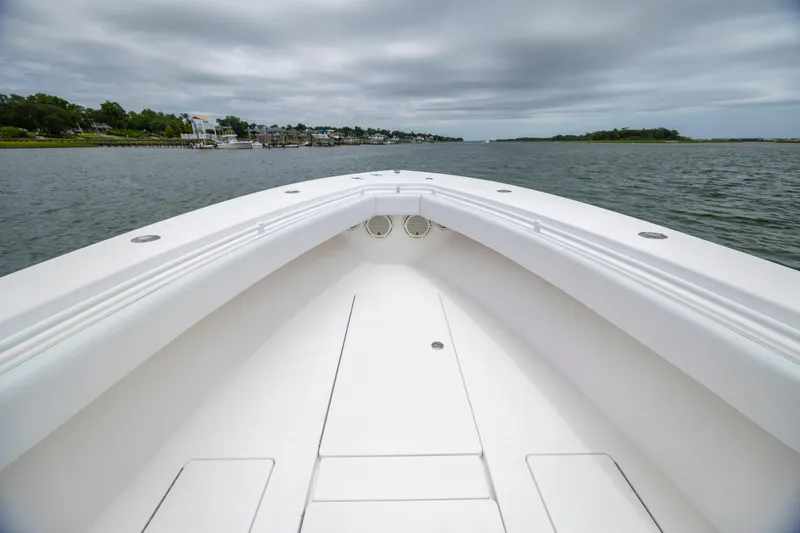 Slide: The Image of 2012 Contender 30 Tournament boat on calm water under cloudy skies. - 22