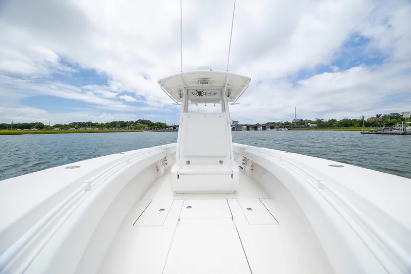 Slide: The Image of 2012 Contender 30 Tournament boat on calm water under a partly cloudy sky. - 23