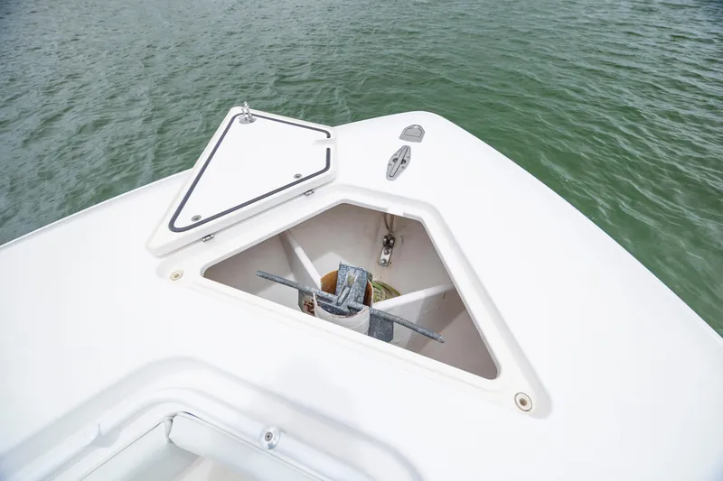 Slide: The Image of 2012 Contender 30 Tournament boat anchor compartment with open hatch on calm water. - 24