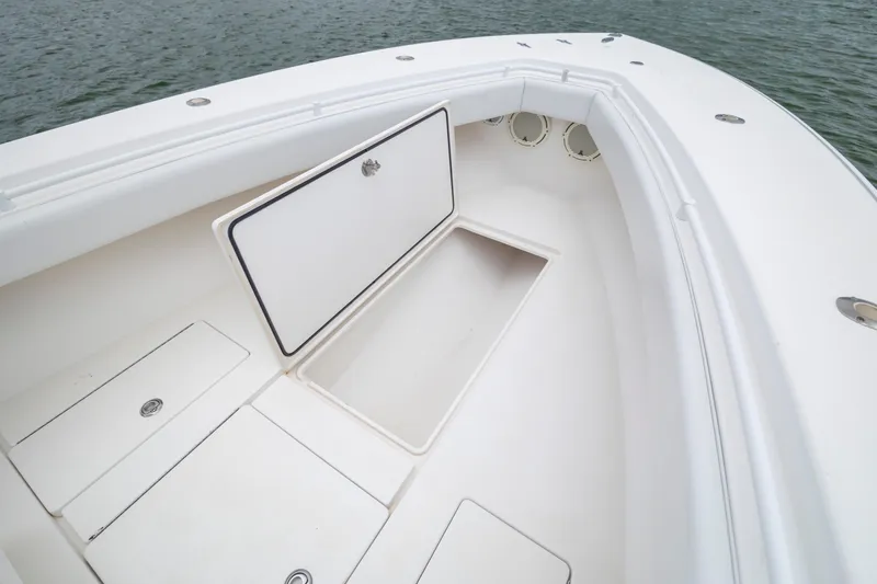 Slide: The Image of 2012 Contender 30 Tournament boat with open storage compartments on deck. - 25