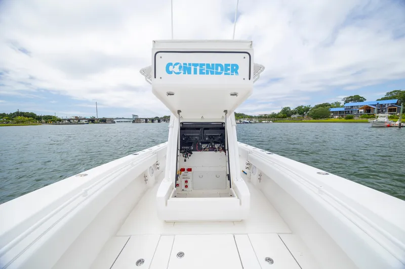 Slide: The Image of 2012 Contender 30 Tournament boat on calm water, showcasing helm and open deck. - 26
