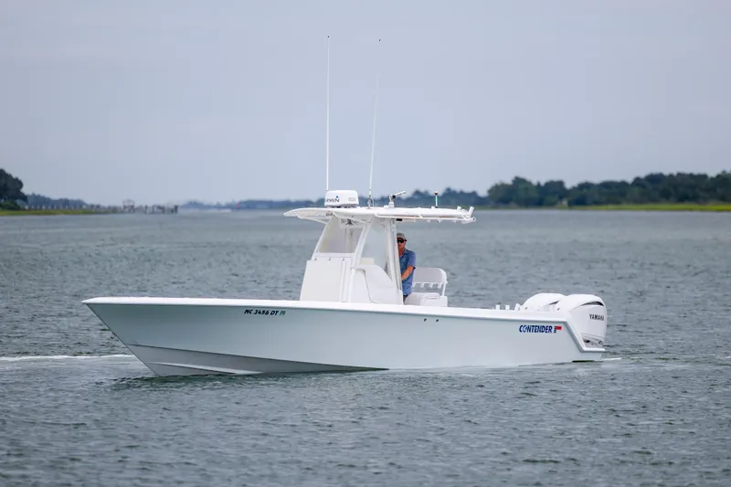 Slide: The Image of 2012 Contender 30 Tournament boat cruising on a calm waterway. - 5