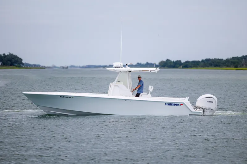 Slide: The Image of 2012 Contender 30 Tournament boat cruising on calm waters with Yamaha outboard engine. - 6