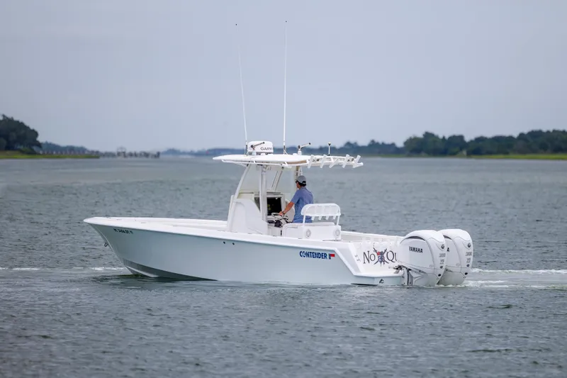 Slide: The Image of 2012 Contender 30 Tournament boat cruising on calm waters with twin Yamaha engines. - 7
