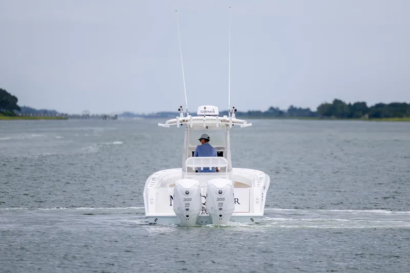 Slide: The Image of 2012 Contender 30 Tournament boat cruising on a calm waterway. - 8