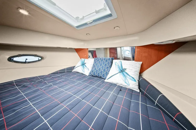 Slide: The Image of Interior cabin of 2008 Formula 40 Performance Cruiser with plaid bedding and decorative pillows. - 16