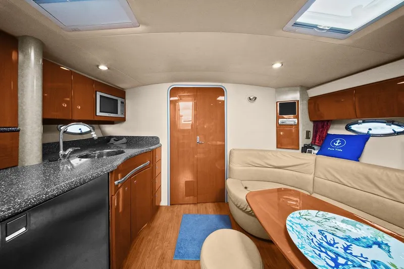 Slide: The Image of Interior of a 2008 Formula 40 Performance Cruiser with modern kitchen and seating area. - 18