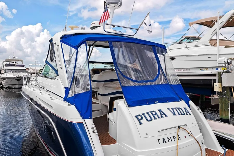 Slide: The Image of 2008 Formula 40 Performance Cruiser docked, featuring blue canopy and "Pura Vida" on the stern. - 2