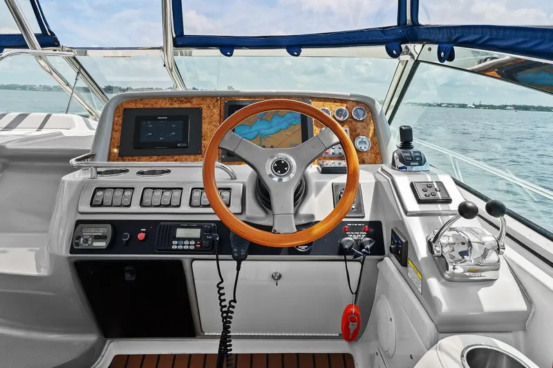 Slide: The Image of 2008 Formula 40 Performance Cruiser helm with navigation controls and wooden steering wheel. - 29
