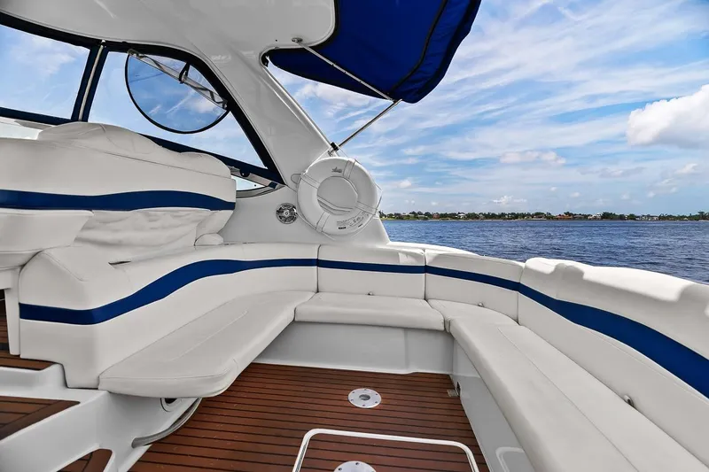 Slide: The Image of 2008 Formula 40 Performance Cruiser interior with white and blue seating, overlooking serene waters. - 34