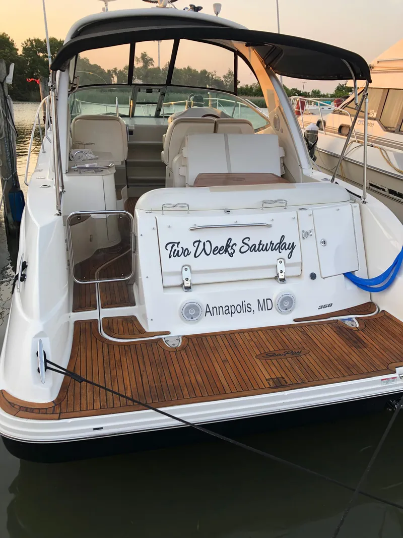 Slide: The Image of 2011 Sea Ray 350 Sundancer docked in Annapolis, MD, with "Two Weeks Saturday" on the stern. - 12