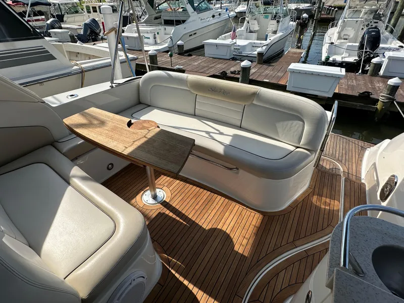 Slide: The Image of Luxurious 2011 Sea Ray 350 Sundancer boat interior with elegant seating and wooden table. - 18