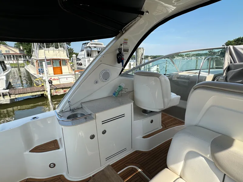 Slide: The Image of 2011 Sea Ray 350 Sundancer interior with seating and dock view. - 23