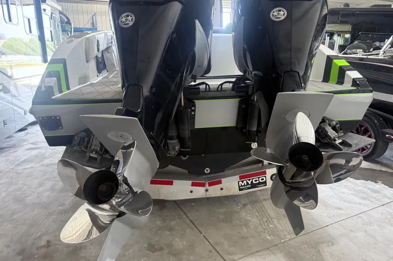 Slide: The Image of 2019 Statement 350 Open boat with dual outboard motors and propellers in a garage. - 11