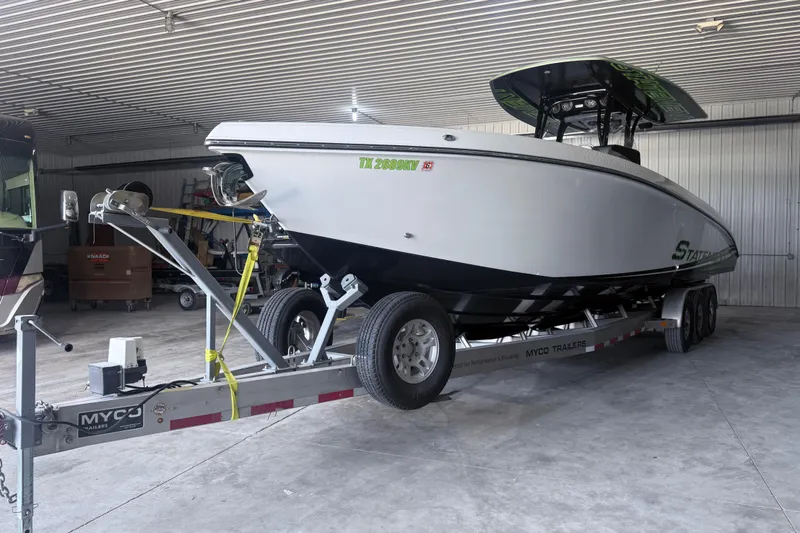 Slide: The Image of 2019 Statement 350 Open boat on trailer in a garage setting. - 5