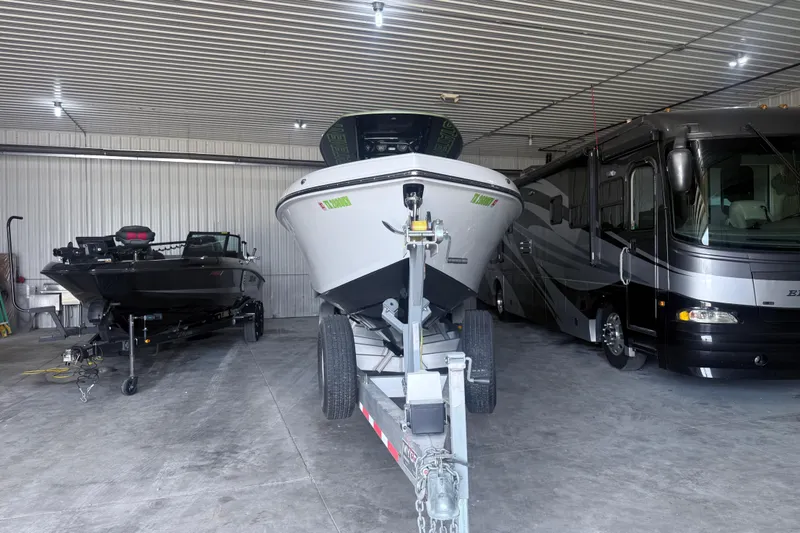 Slide: The Image of 2019 Statement 350 Open boat in storage with RV and another boat. - 6