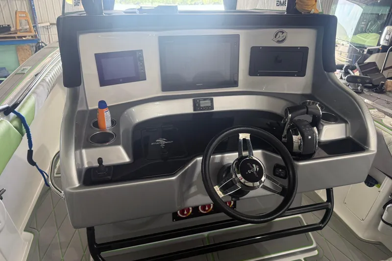 Slide: The Image of 2019 Statement 350 Open boat dashboard with steering wheel and electronic displays. - 7