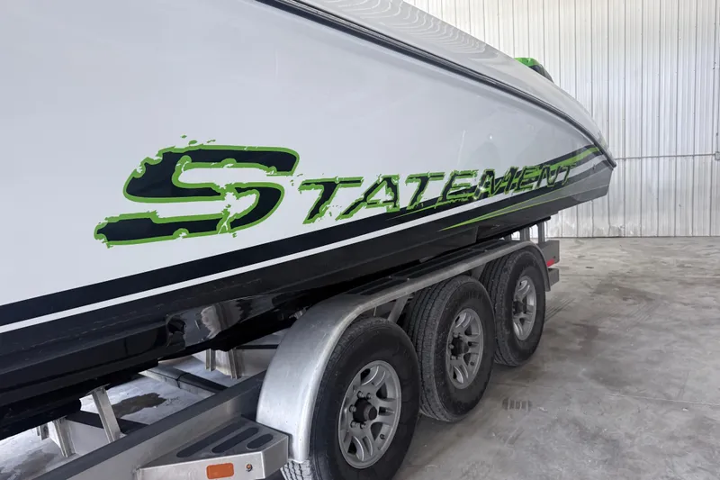 Slide: The Image of 2019 Statement 350 Open boat on trailer in warehouse setting. - 9