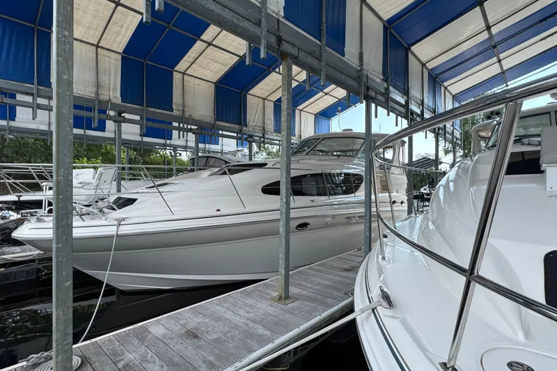 Slide: The Image of 2004 Sea Ray 390 Motor Yacht docked under blue canopy. - 1