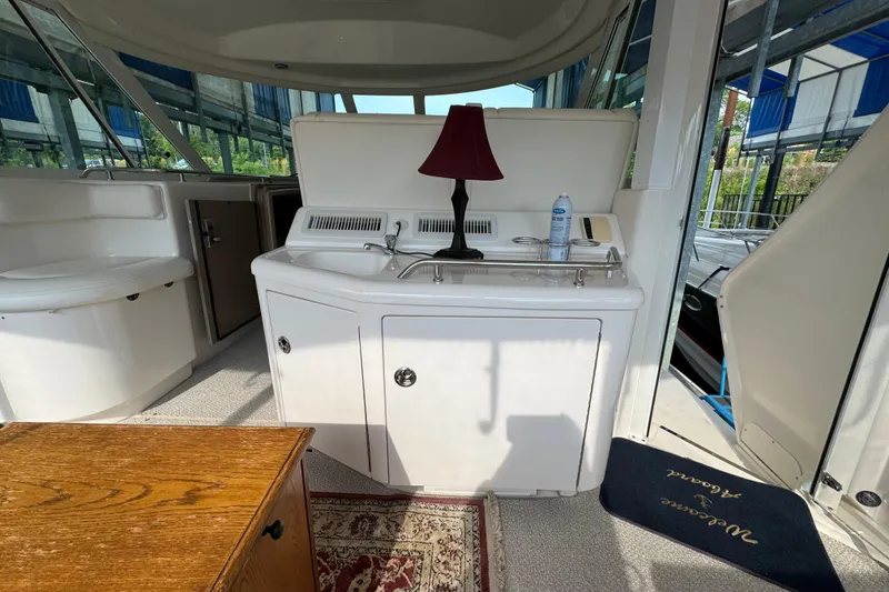Slide: The Image of Interior of 2004 Sea Ray 390 Motor Yacht with sink, lamp, and seating area. - 12