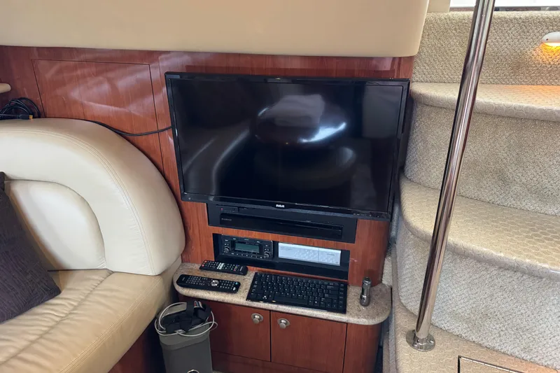 Slide: The Image of Interior of 2004 Sea Ray 390 Motor Yacht with TV, stairs, and seating area. - 24