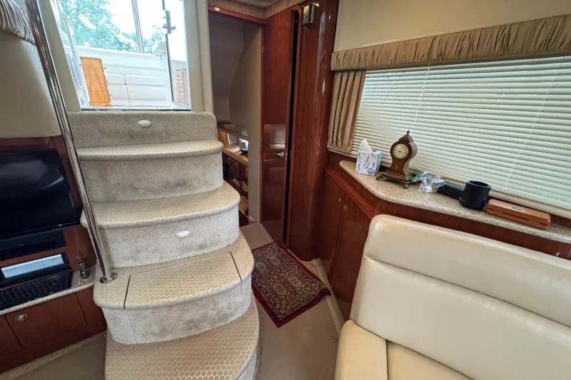 Slide: The Image of Interior of 2004 Sea Ray 390 Motor Yacht with carpeted stairs and elegant decor. - 26